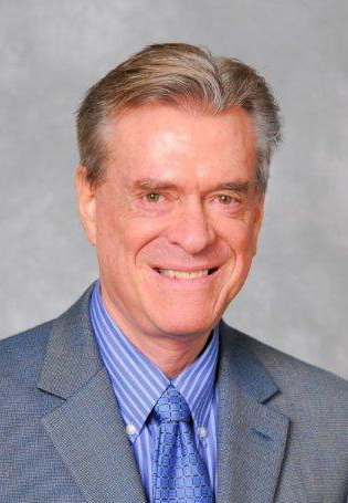 A person in a suit smiling

AI-generated content may be incorrect.