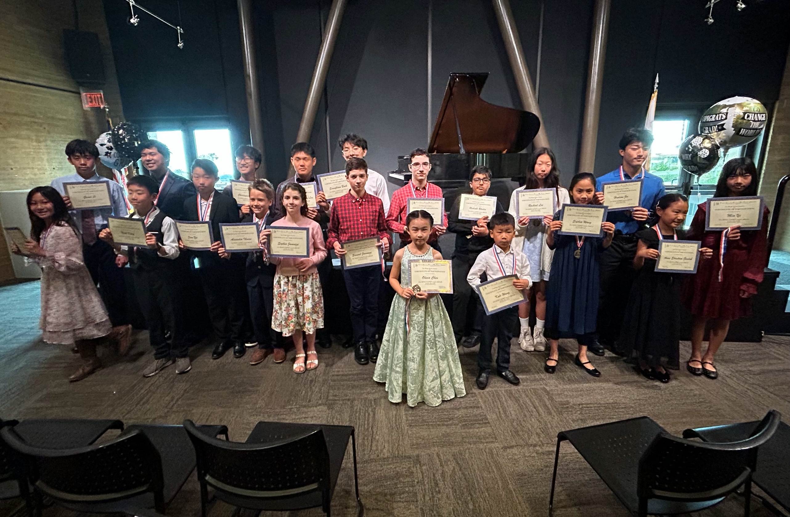 A group of people holding certificates